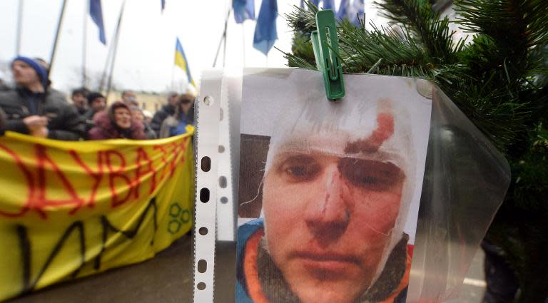 A portrait of a wounded protester hangs on a Christmas tree in front of Rinat Akhmetov's office in Kiev, on December 18, 2013