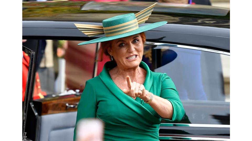 Sarah, Duchess of York in a green outfit as she pointed to crowds at Eugenie's wedding