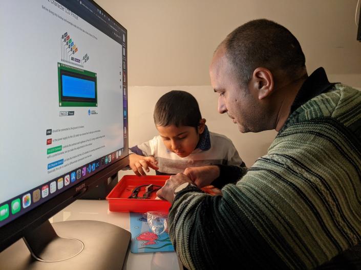 Amit Kumar and his son, Ray, work on a do-it-yourself electronics project. Ray, who has autism, responded quickly to the standard treatment, but the family's health plan in Virginia, Anthem Blue Cross and Blue Shield, said it was not included or not medically necessary. The family moved to Irvine, California in 2021 solely because California more strictly regulates coverage.