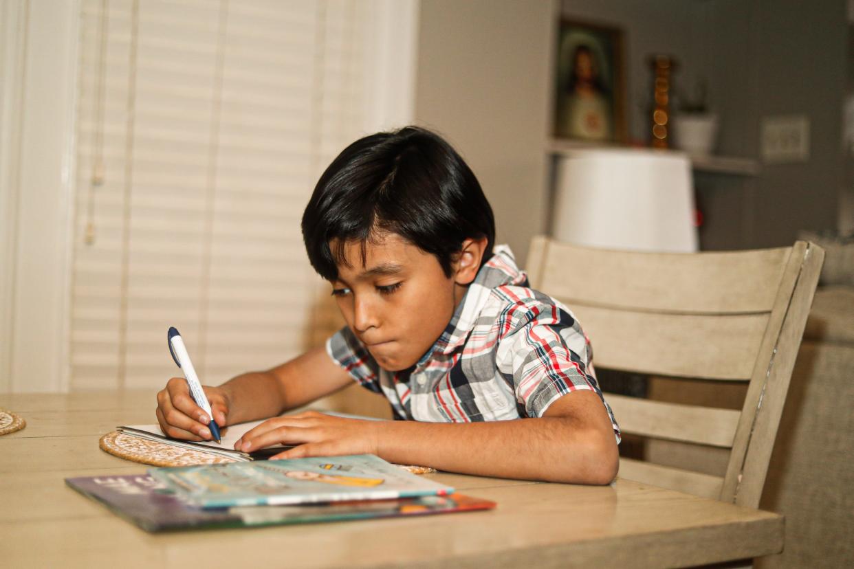 Diego Rivera works on his school work at the table at her parents’ home on Friday, March 1, 2024 in Memphis, Tenn.