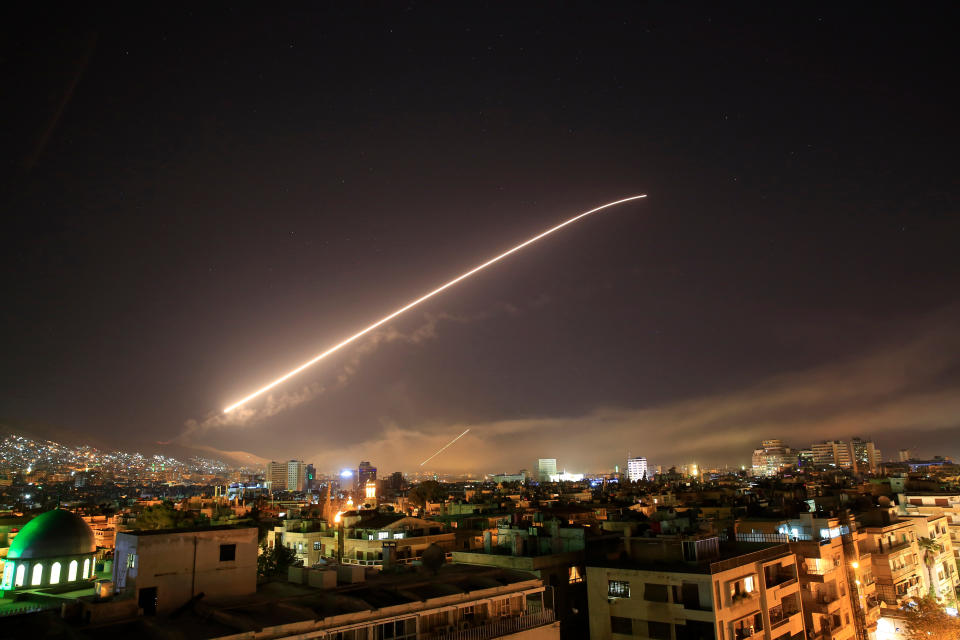 File - In this Saturday, April 14, 2018 file photo, air defense missiles are seen over Damascus as the U.S. launches an attack on Syria targeting different parts of the capital early. Syria's capital has been rocked by loud explosions that lit up the sky with heavy smoke as U.S. President Donald Trump announced airstrikes in retaliation for the country's alleged use of chemical weapons. (AP Photo/Hassan Ammar, File)