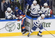 Tampa Bay Lightning center Anthony Cirelli (71) checks New York Islanders right wing Cal Clutterbuck (15) into the Lightning's bench during the third period of Game 6 of the NHL hockey Eastern Conference final, Thursday, Sept. 17, 2020, in Edmonton, Alberta. (Jason Franson/The Canadian Press via AP)