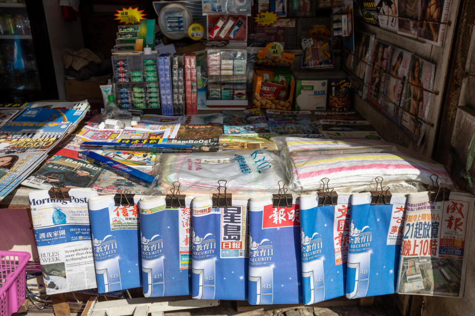 Hong Kong - April 15, 2022 : Newspapers feature a government-sponsored advertisement on the front page promoting the National Security Education Day, at a news stand in Kowloon, Hong Kong.