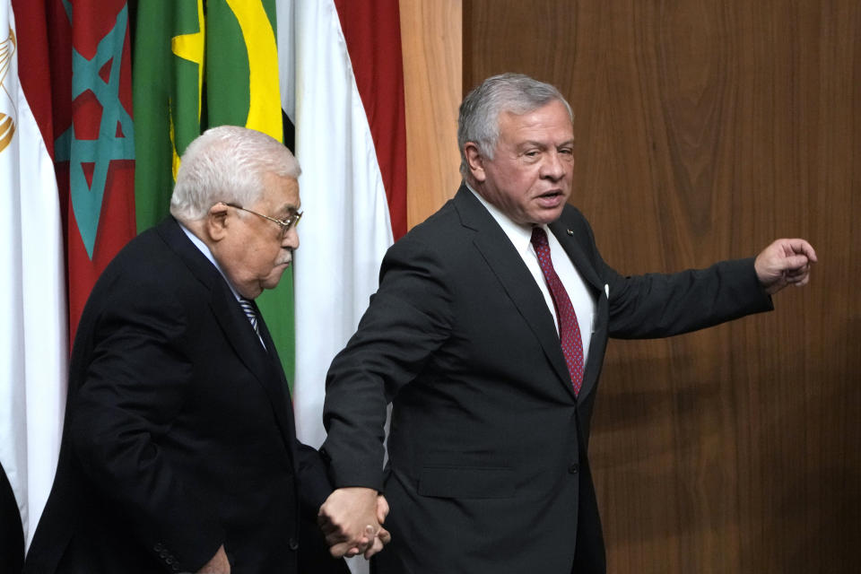 Palestinian President Mahmoud Abbas, left, is accompanied by King Abdullah II of Jordan, during a conference to support Jerusalem at the Arab League headquarters in Cairo, Egypt, Sunday, Feb. 12, 2023. (AP Photo/Amr Nabil)