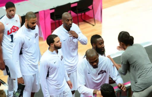 US basketball players are congratulated by US First Lady Michelle Obama after they won 98-71 the Men's Preliminary Round Group A match United States vs France at the London 2012 Olympic Games