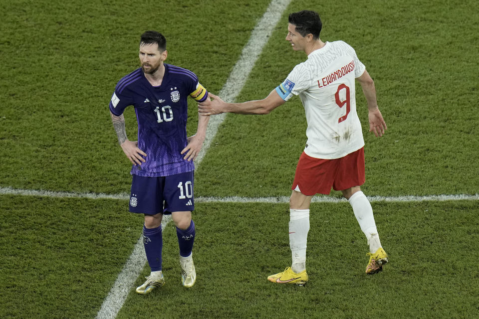 Poland's Robert Lewandowski, right, interacts with Argentina's Lionel Messi at the end of the World Cup group C soccer match between Poland and Argentina at the Stadium 974 in Doha, Qatar, Wednesday, Nov. 30, 2022. (AP Photo/Hassan Ammar)