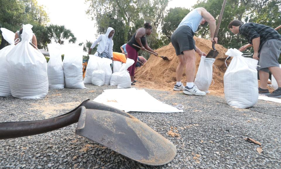 Residents fill sandbags on Monday morning at the Daytona Beach site on Jean Street as Hurricane Ian moves toward Florida.