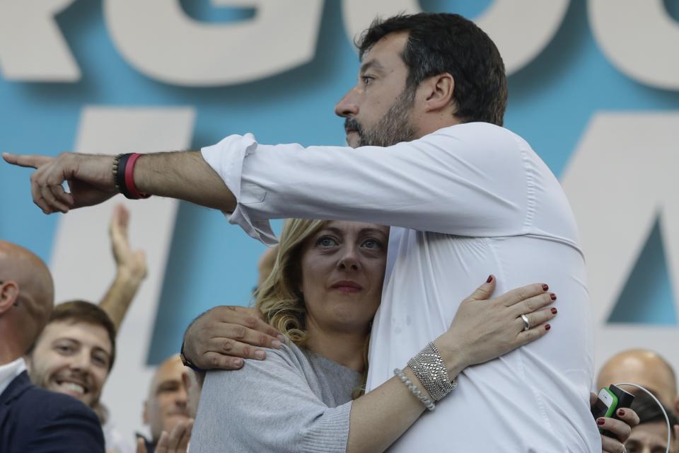 Giorgia Meloni and Matteo Salvini, right, hug each other as they address a rally in Rome, Saturday, Oct. 19, 2019. Thousands of protesters are gathering in Rome for a so-called "Italian Pride" rally, which brings together the right-wing League of Salvini, the far-right Brothers of Italy of Giorgia Meloni and former premier Silvio Berlusconi's Forza Italia. (AP Photo/Andrew Medichini)