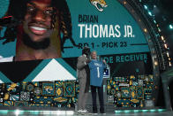 LSU wide receiver Brian Thomas Jr. poses with NFL Commissioner Roger Goodell after being chosen by the Jacksonville Jaguars with the 23rd overall pick during the first round of the NFL football draft, Thursday, April 25, 2024, in Detroit. (AP Photo/Jeff Roberson)