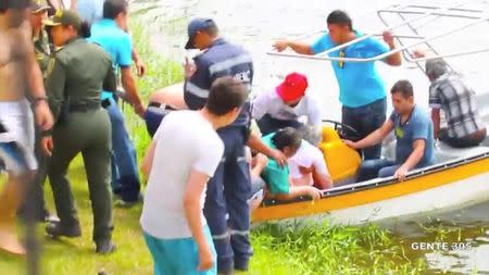 People on a boat rescue passengers of a sinking tourist ferry (not pictured) in the Guatape reservoir in Colombia June 25, 2017 in this still image taken from video obtained from social media. Juan Quiroz/via REUTERS