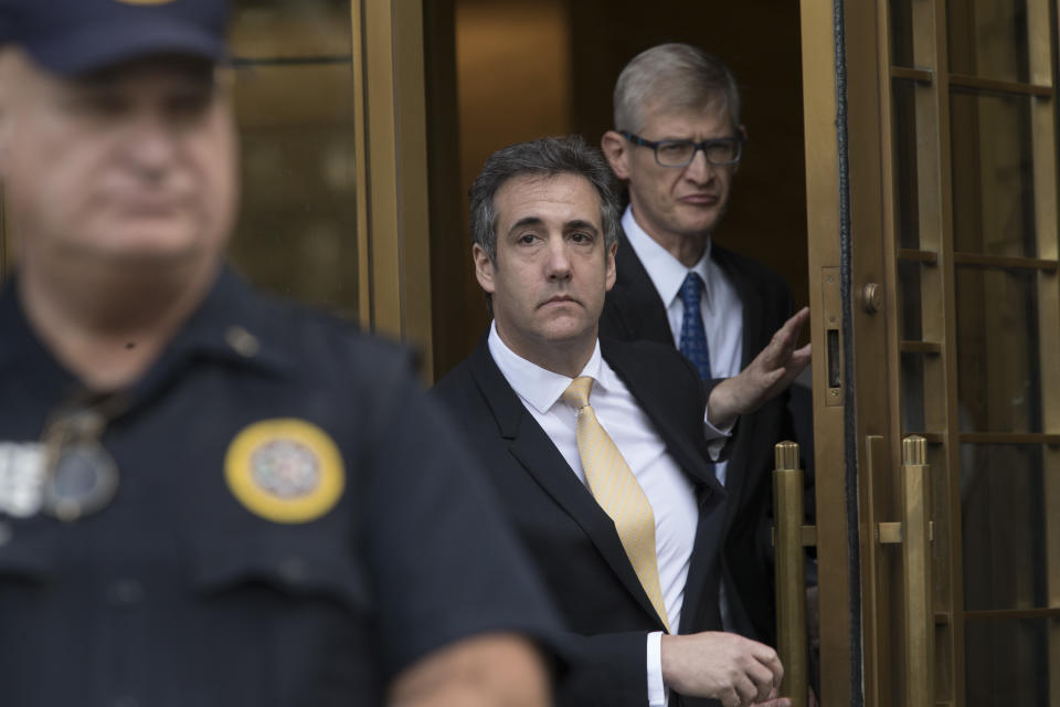 Michael Cohen, center, leaves Federal court, Tuesday, Aug. 21, 2018, in New York. Cohen, has pleaded guilty to charges including campaign finance fraud stemming from hush money payments to porn actress Stormy Daniels and ex-Playboy model Karen McDougal. (AP Photo/Mary Altaffer)