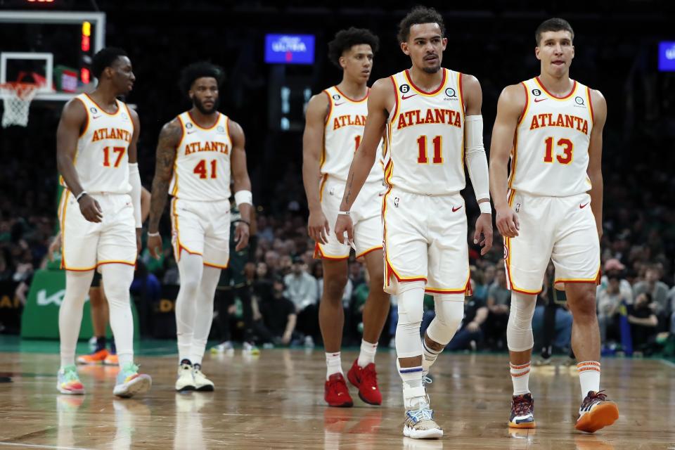 Atlanta Hawks players, from left, Onyeka Okongwu, Saddiq Bey, Jalen Johnson, Trae Young and Bogdan Bogdanovic walk to the bench at the end of the third quarter in Game 1 in the first round of the NBA basketball playoffs, Saturday, April 15, 2023, in Boston. (AP Photo/Michael Dwyer)