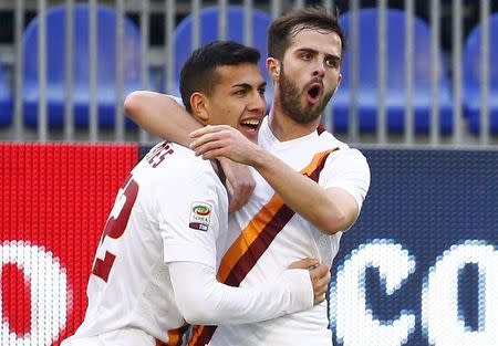 AS Roma's Leandro Paredes (L) celebrates with Miralem Pjanic after scoring against Cagliari during their Italian Serie A soccer match at the Sant'Elia stadium in Cagliari, February 8, 2015. REUTERS/Tony Gentile