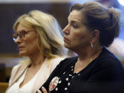 Gail Box, right, the mother of former University of Oklahoma football player Austin Box, who died of a drug overdose in 2011, listens during the Opioid trial in Norman, Okla., Monday, June 24, 2019. Judge Thad Balkman announced Monday that he has signed off on the state's $85 million settlement with Israeli-owned Teva Pharmaceuticals, following a squabble between the attorney general, Legislature and governor over how the deal was structured. (AP Photo/Sue Ogrocki)