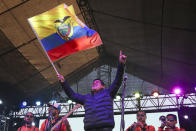 Andres Arauz, presidential candidate of the Alianza Union por la Esperanza, UNES, party waves an Ecuador national flag at his campaign headquarters in Quito, Ecuador, after the closing of the polls for a runoff presidential election Sunday, April 11, 2021. Ecuadorians voted Sunday to choose between Arauz, an economist protégé of former President Rafael Correa, and former banker Guillermo Lasso, of Creating Opportunities party, or CREO. (AP Photo/Dolores Ochoa)