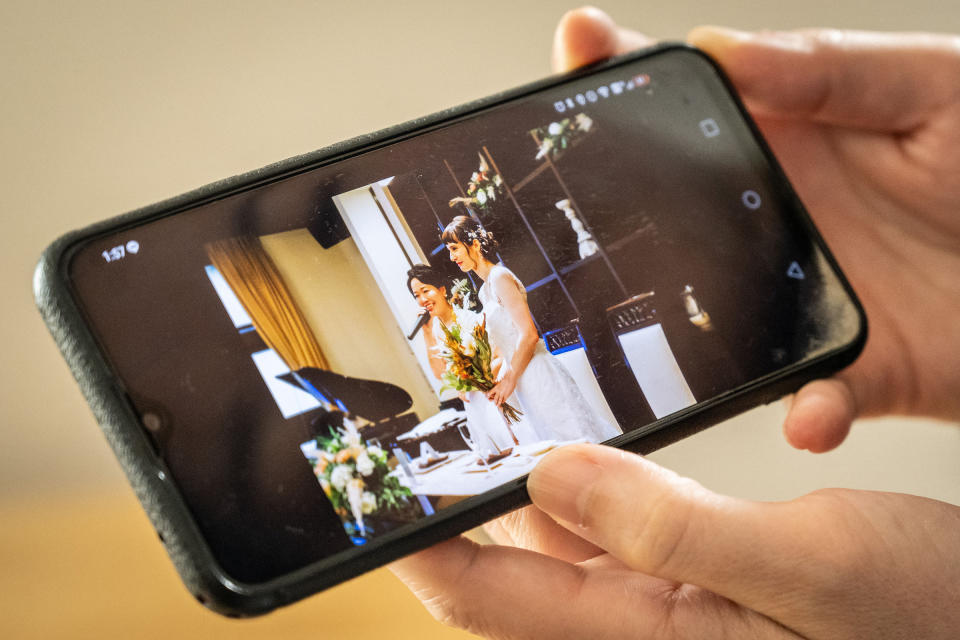 Miki showing a picture of her wedding with her partner Katie at their home in Tokyo, Oct 30. Tokyo began issuing partnership certificates to same-sex couples who live and work in the capital on Nov. 1, a long-awaited move in a country without marriage equality.<span class="copyright">Yuichi Yamazaki—AFP/Getty Images</span>