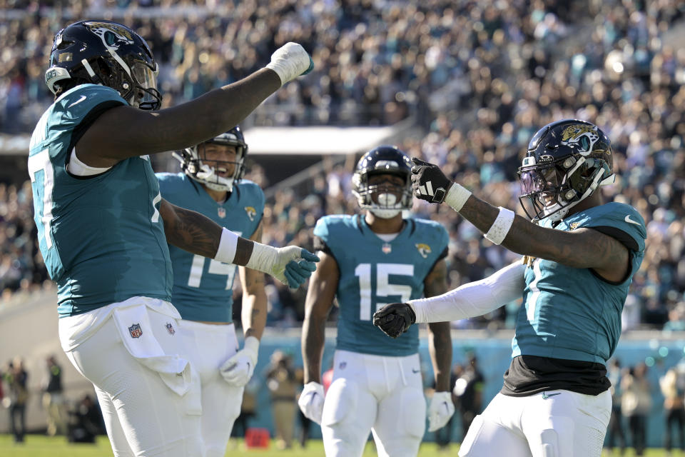 Jacksonville Jaguars running back Travis Etienne Jr. (1) celebrates after a touchdown against the Carolina Panthers during the second half of an NFL football game Sunday, Dec. 31, 2023, in Jacksonville, Fla. (AP Photo/Phelan M. Ebenhack)