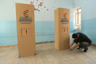 A Kurdish employee sets up a voting booth for the September 25th independence referendum in Duhok, Iraq September 24, 2017. REUTERS/Ari Jalal