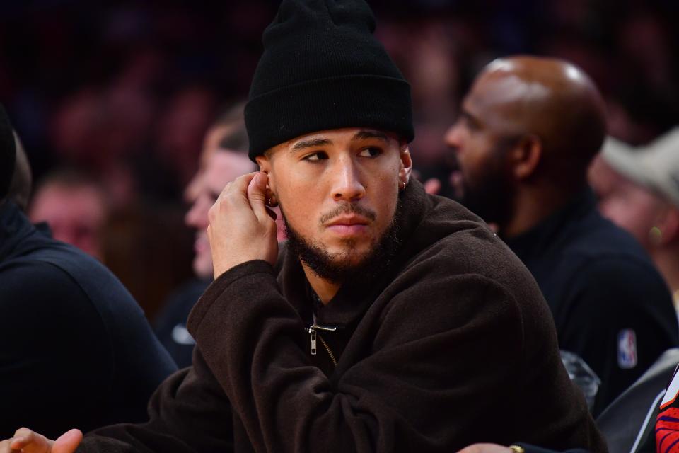 Phoenix Suns guard Devin Booker (1) watches game action against the Los Angeles Lakers during the first half at Crypto.com Arena in Los Angeles on Oct. 26, 2023.