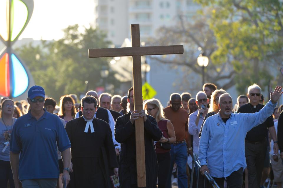 Last year's procession moves along Main Street to the 8th Station of the Cross.