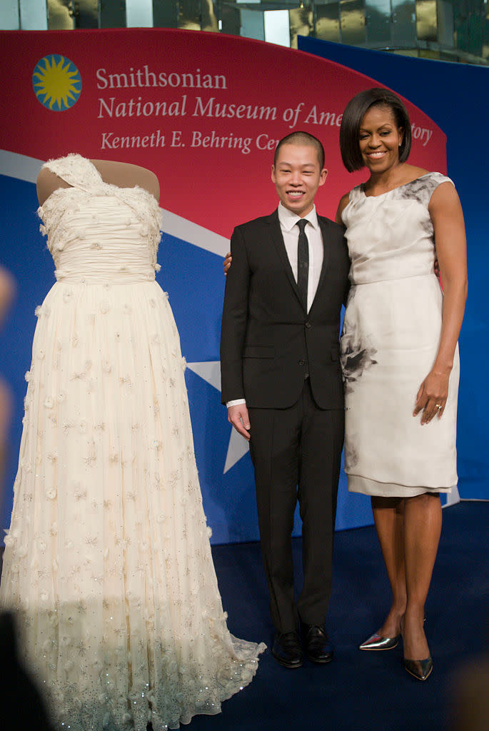 In 2010, FLOTUS stands with Wu as the dress he designed for her first Inaugural Ball is inducted into the Smithsonian Institute. (Photo: Getty)