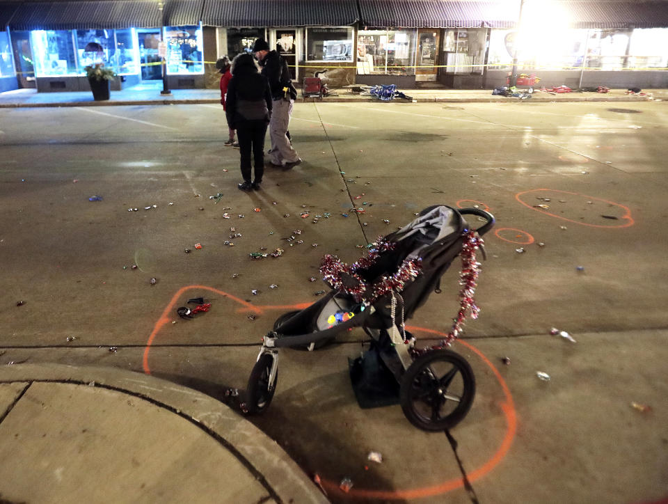 A broken children's stroller lays on W. Main St. in downtown Waukesha, Wis., after an SUV drove into a parade of Christmas marchers Sunday, Nov. 21, 2021. (John Hart/Wisconsin State Journal via AP)