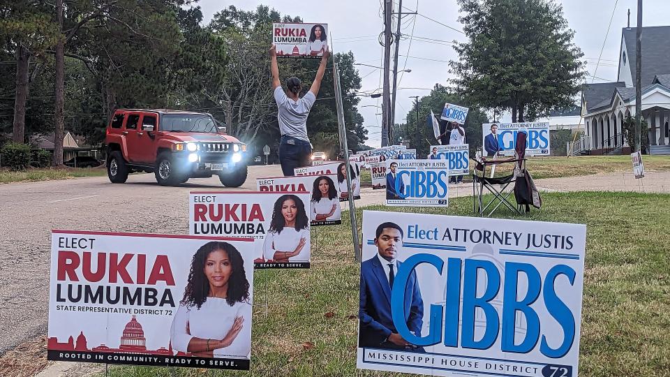 People campaign outside the poll at Aldersgate United Methodist Chruch in Jackson during the run-off election Tuesday.