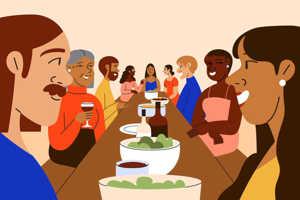 A multiracial group of friends gather for a holiday dinner party at a long shared table. Avoid arriving at events on an empty stomach. (Getty)