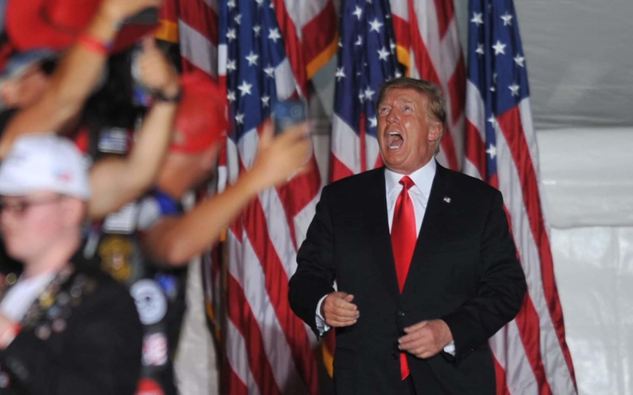 Former US President Donald J. Trump gestures to supporters - Shutterstock 