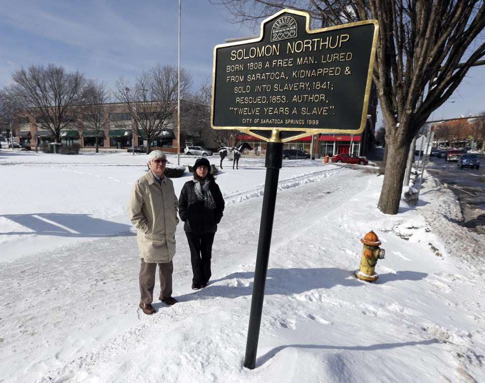 David Fiske, left, and Rachel Seligman, two of the co-authors of “Solomon Northup: The Complete Story of the Author of Twelve Years a Slave," pose at the Solomon Northup historical marker on Thursday, March 13, 2014, in Saratoga Springs, N.Y. (AP Photo/Mike Groll)