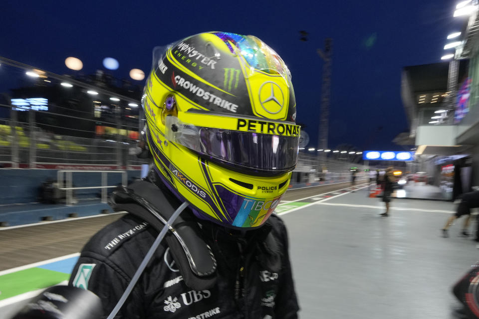 Mercedes driver Lewis Hamilton of Britain walks during practice session of the Singapore Formula One Grand Prix, at the Marina Bay City Circuit in Singapore, Friday, Sept. 30, 2022. (AP Photo/Vincent Thian)