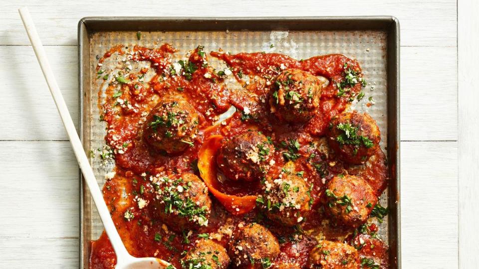 red sauce sausage meatballs on a sheet tray