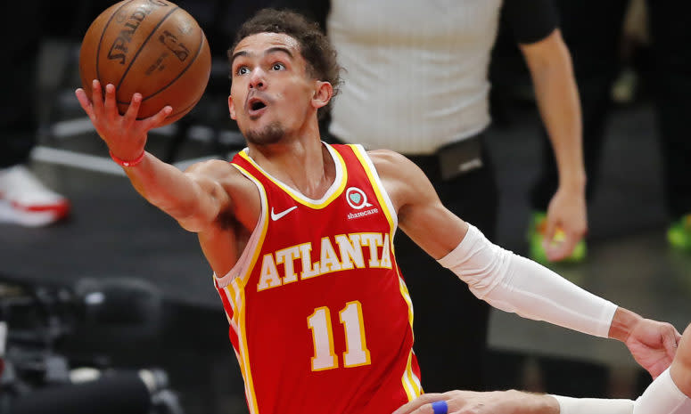 Hawks point guard Trae Young goes up for a finger roll layup.