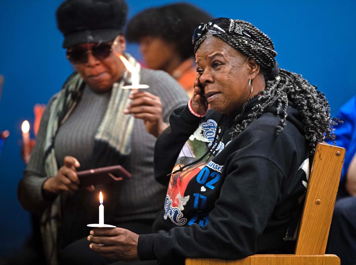 Julie Powells wipes her eyes during a candlelit vigil honoring and remembering victims of violence in Milwaukee at House of Prayer in Milwaukee, Wis. on Saturday, Dec. 9, 2023. Powells lost her son to gun violence.