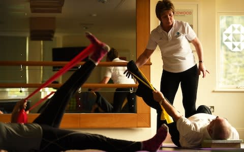 Anna Bauer puts residents through a pilates class routine - Credit: Russell Sach 