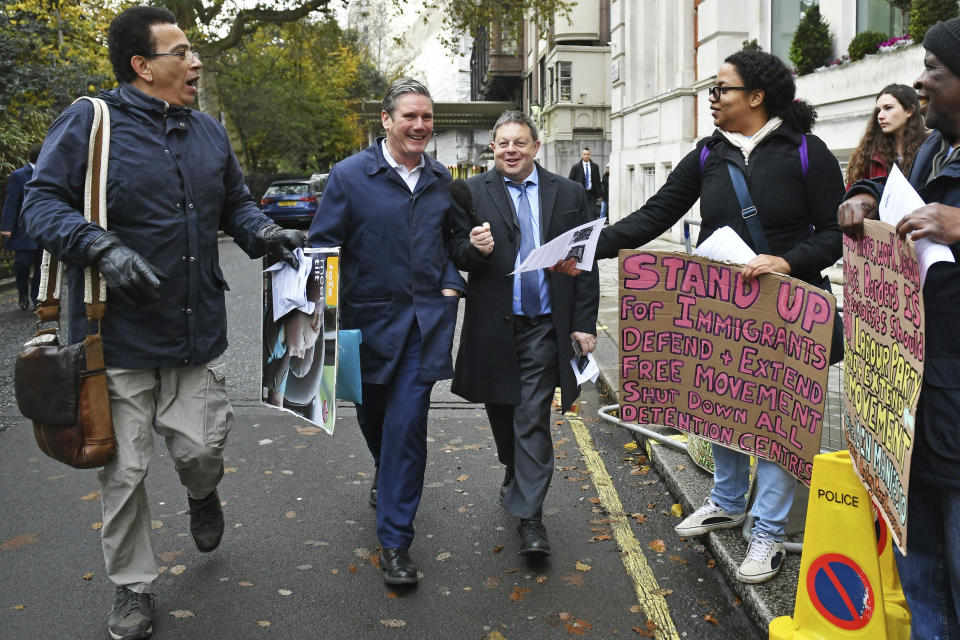 Britain's main opposition Labour Party Shadow Brexit secretary Keir Starmer, 2nd left, is greeted by pro-immigration protesters ahead of a meeting to finalise the manifesto details that will form Labour Party policy for the upcoming General Election in London, Saturday Nov. 16, 2019. Britain's Brexit is one of the main issues for voters and political parties as the UK goes to the polls in a General Election on Dec. 12. (Dominc Lipinski/PA via AP)