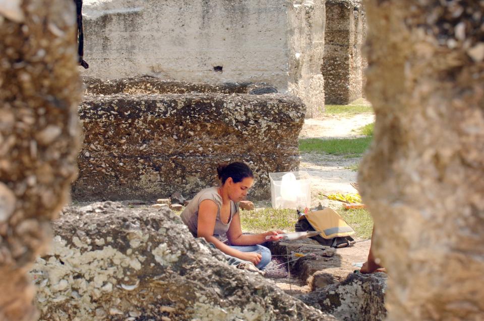 In this 2009 photo, University of Florida student Anastasia Palaia removes a thin layer of dirt looking for evidence of time and people in the slave quarters on Kingsley Plantation.