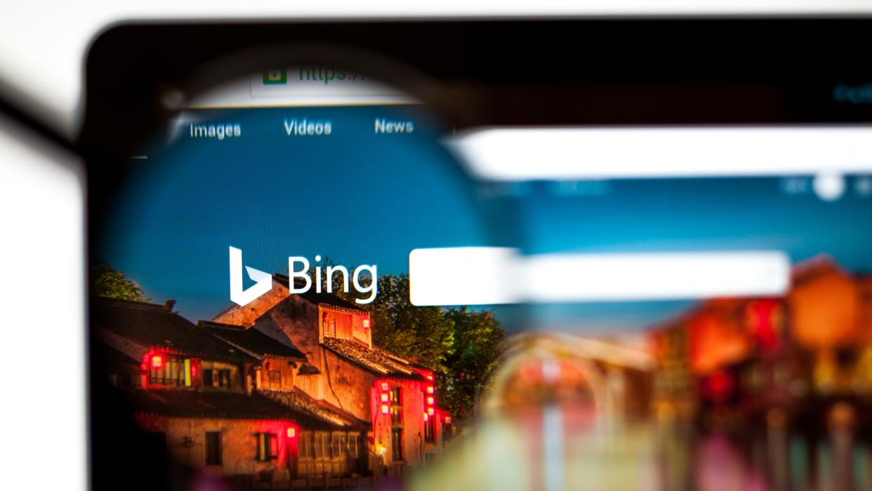  Bing.com website homepage viewed through a magnifying glass. 