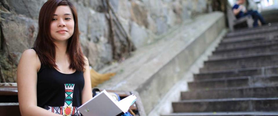 Girl open book on the street