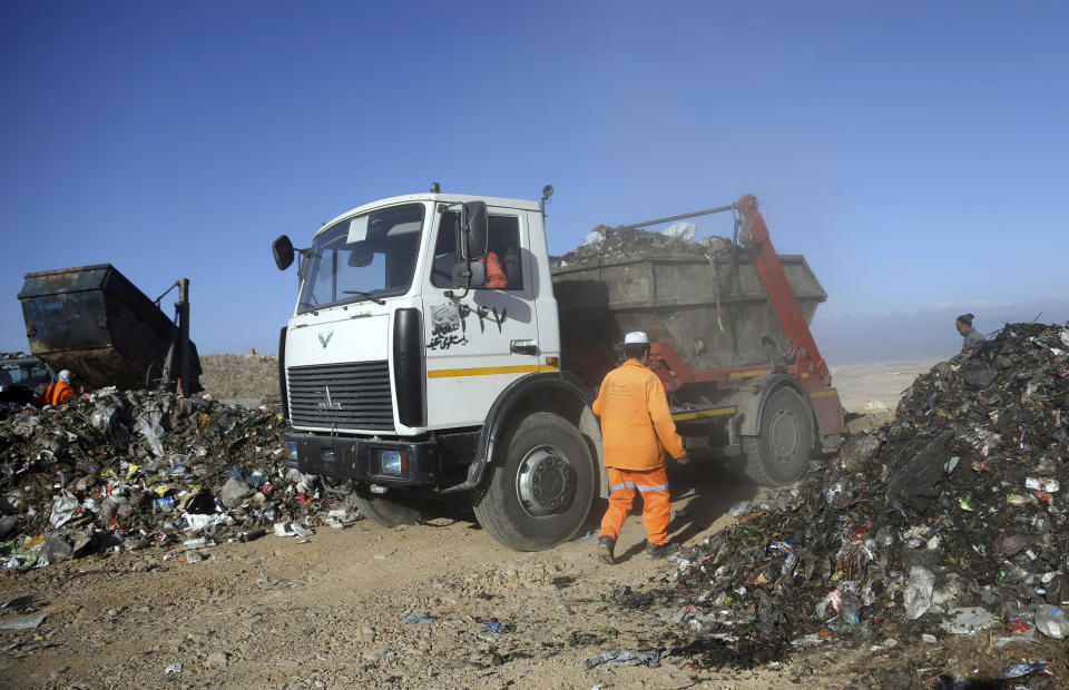 In this Oct. 23, 2019 photo, trucks unload garbage at the Kabul Municipality dump yard, on the outskirts of Kabul, Afghanistan. Authorities are trying to tackle pollution in the country’s capital, which may be even deadlier than 18-year-old war. Most days a layer of smog covers Kabul, and it gets worse in the winter, when people burn coal, garbage, plastic and rubber to heat their homes. (AP Photo/Rahmat Gul)
