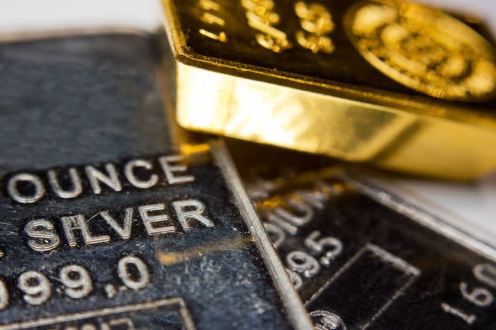 Gold and silver ingots lying atop one another.