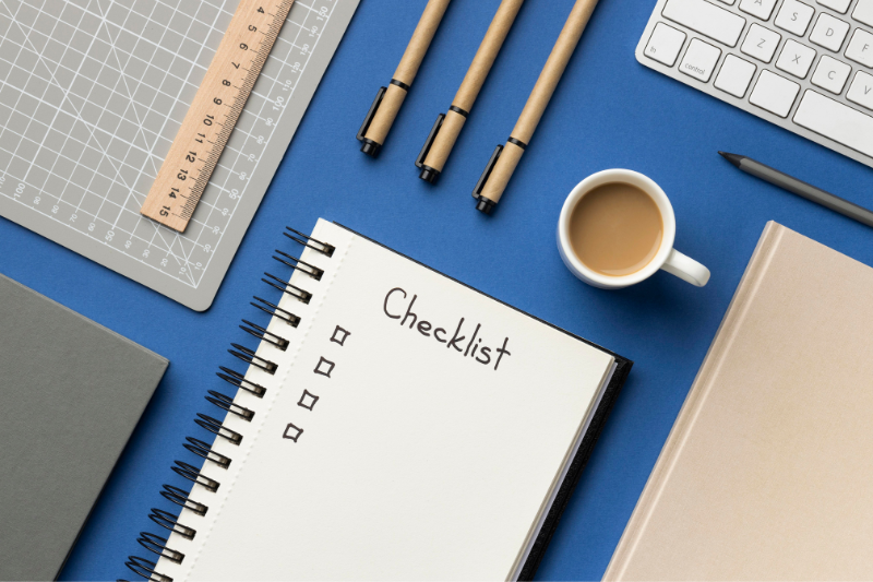 Checklist in Notebook on Blue Background