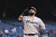 Miami Marlins' Sandy Leon points to the sky as he arrives at home plate after hitting a home run against the Arizona Diamondbacks during the second inning of a baseball game Wednesday, May 12, 2021, in Phoenix. (AP Photo/Ross D. Franklin)