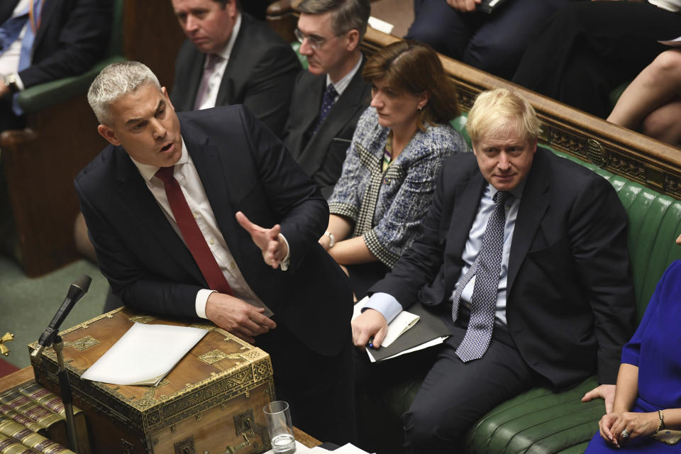 Secretary of State for Exiting the European Union lawmaker Stephen Barclay speaks during the Brexit debate, watched by Prime Minister Boris Johnson, right, inside the House of Commons in London Saturday Oct. 19, 2019. At the rare weekend sitting of Parliament, Prime Minister Boris Johnson implored legislators to ratify the Brexit deal he struck this week with the other 27 EU leaders. Lawmakers voted Saturday in favour of the 'Letwin Amendment', which seeks to avoid a no-deal Brexit on October 31. (Jessica Taylor/House of Commons via AP)