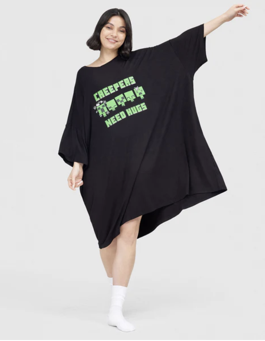 Woman in long-line Minecraft Creeper sleep tee