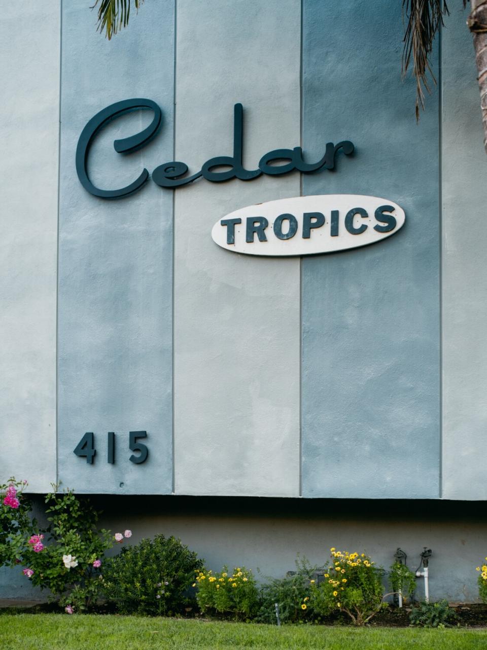 Apartment building sign that reads "Cedar Tropics 415."