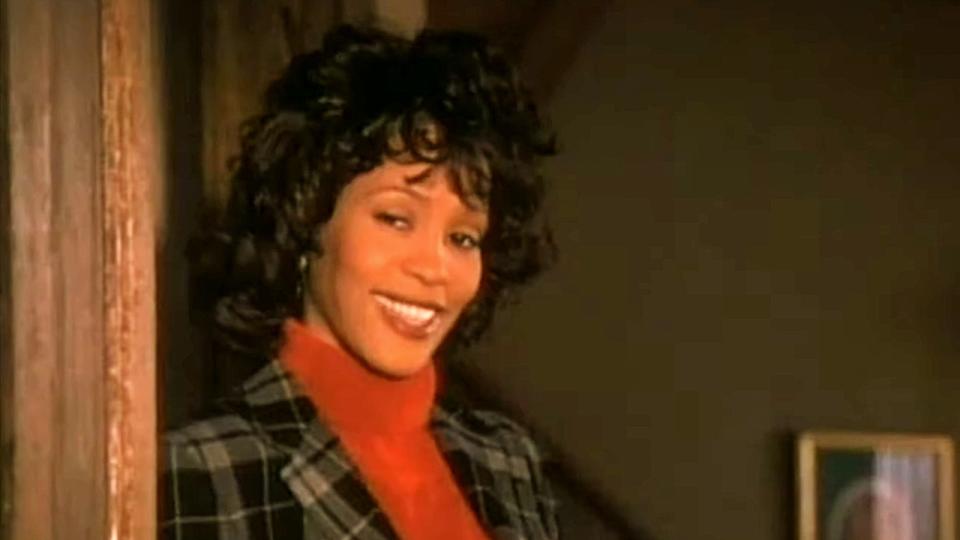 Julia Coleman Biggs (Whitney Houston) grinning in The Preacher's Wife