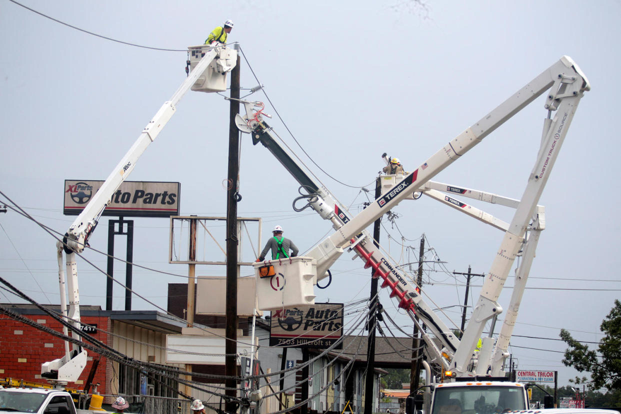 Utility crews  (Lekan Oyekanmi / AP)