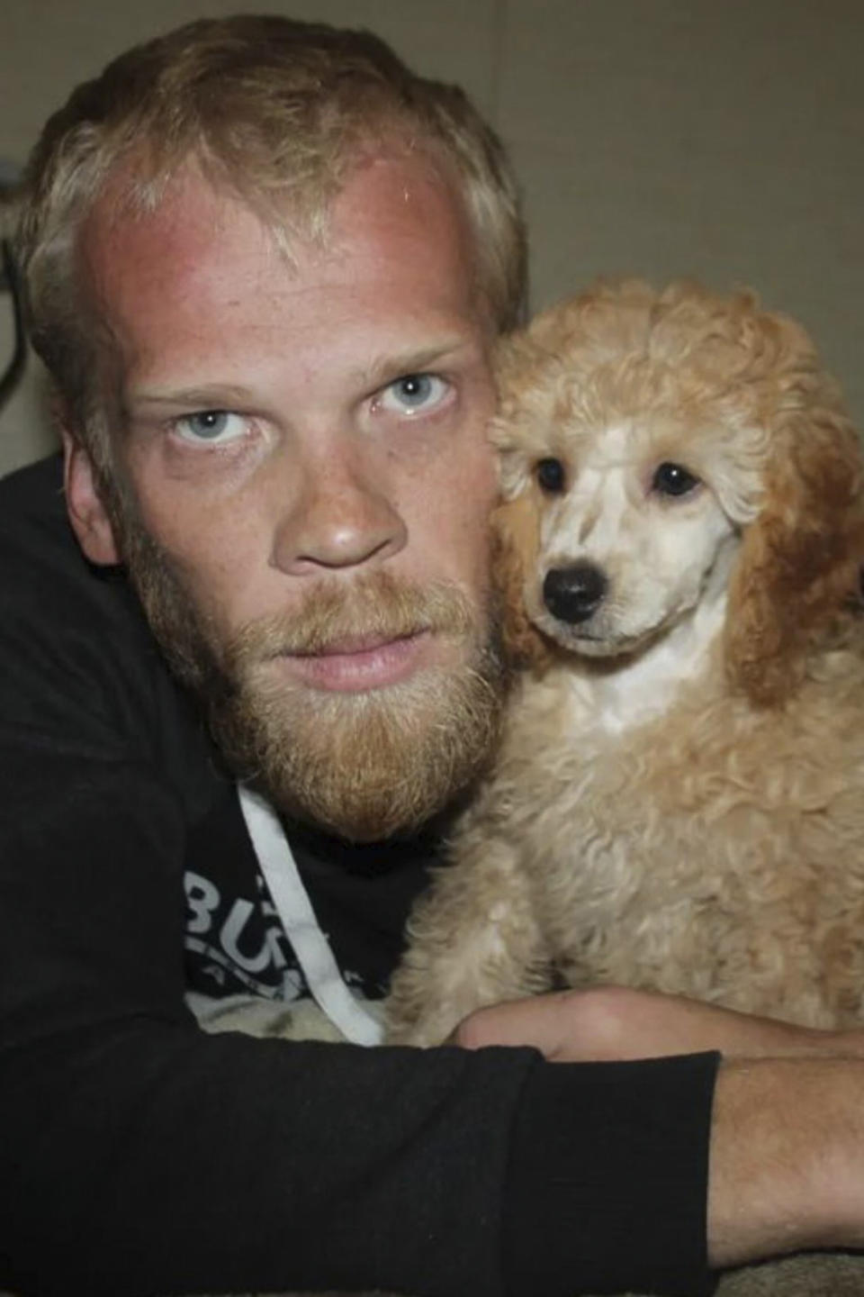 This photo provided by his family shows Yevhen Pryshliak with the toy poodle he bought during the coronavirus pandemic. On the night of Aug. 15, 2022, Pryshliak decided to stay at the apartment of his friend, Artem Baranov, in the Kherson region, rather than risk being caught breaking the Russian curfew. Neighbors later told the family that 15 armed Russian soldiers swooped in, ransacked the apartment and seized the men. (Family photo via AP)