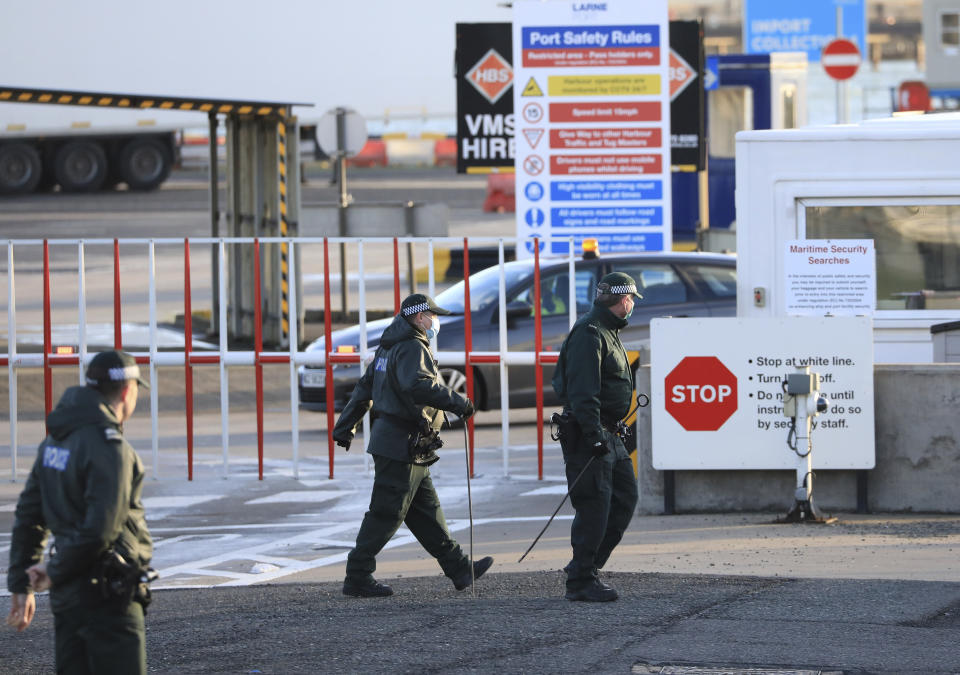 Police conduct a security sweep at the P&O ferry terminal in the port at Larne on the north coast of Northern Ireland, Friday, Jan. 1, 2021. This New Year's Day is the first day after Britain's Brexit split with the European bloc's vast single market for people, goods and services, and the split is predicted to impact the Northern Ireland border. (AP Photo/Peter Morrison)